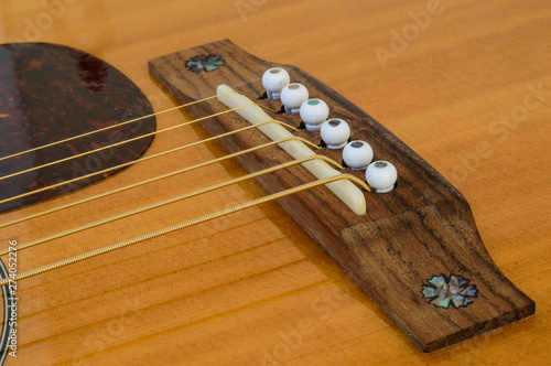 Acoustic Guitar detail - bridge, saddle and pins - above top photo