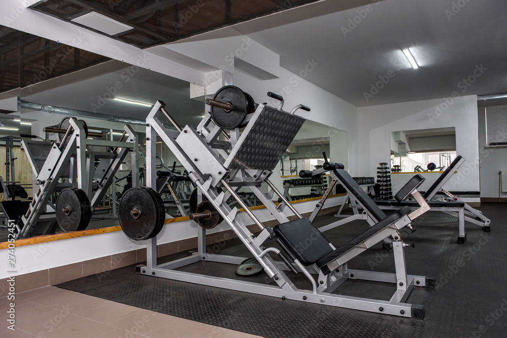 Fototapeta premium Different sport equipment in modern gym closeup