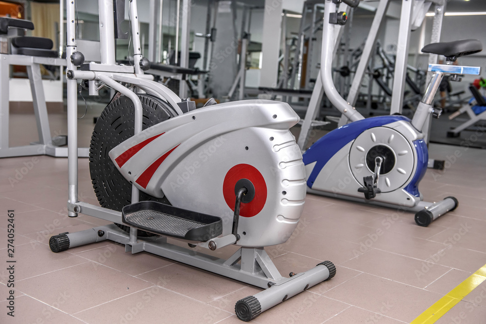 Two exercise bikes in the gym . Two exercise bikes in the gym .