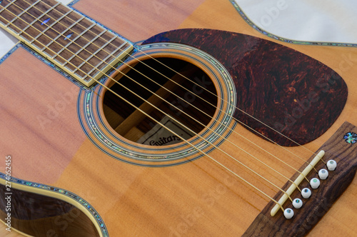 Acoustic Guitar detail - sound hole and scratch plate - from top photo