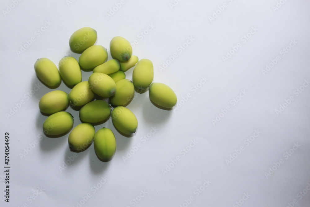 Lotus (Nelumbo nucifera) seeds against white background.Also known as sacred lotus, bean of India, Egyptian bean Lotus (Nelumbo nucifera) seeds against white background.Also known as sacred lotus, bean of India, Egyptian bean