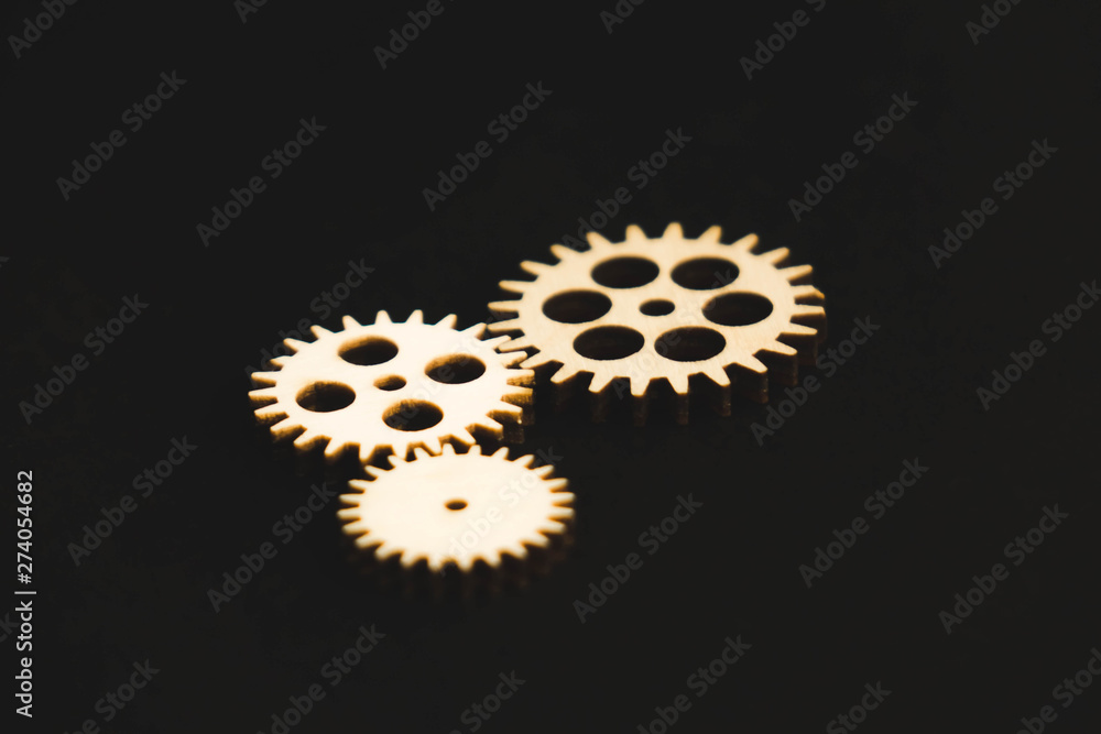 mechanisms of wood on a black background gear mechanisms of wood on a black background gear