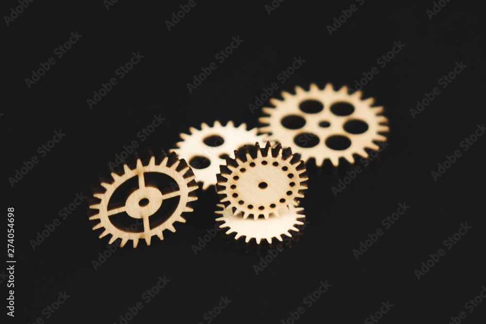 mechanisms of wood on a black background gear mechanisms of wood on a black background gear