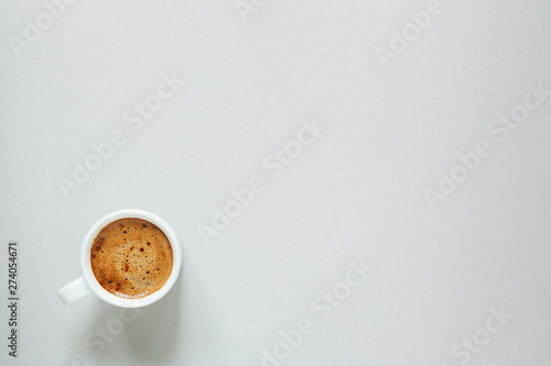 morning cup of coffee on light background, top view, copy space