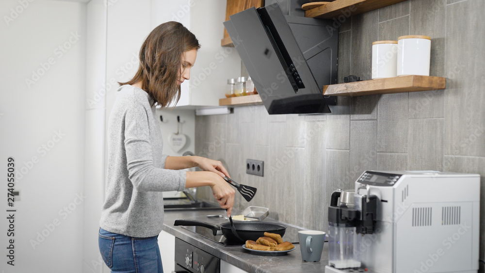 Young lady preparing food in modern kitchen Young lady preparing food in modern kitchen