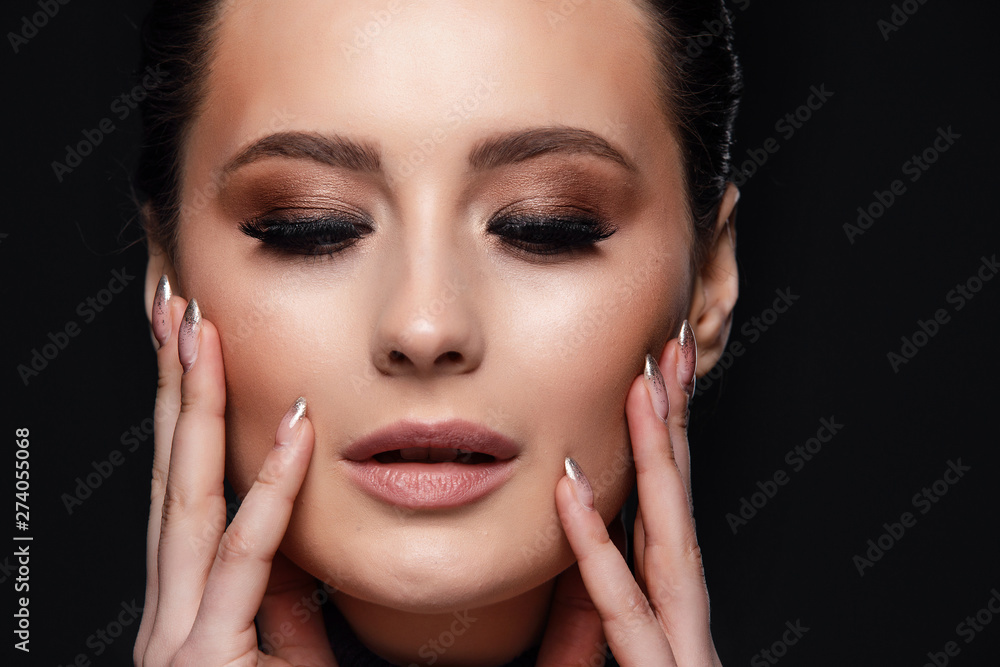 Beauty Cosmetics.Woman applying black mascara on eyelashes with makeup brush. photos of appealing brunette girl on black background.High Resolution Beauty Cosmetics.Woman applying black mascara on eyelashes with makeup brush. photos of appealing brunette girl on black background.High Resolution