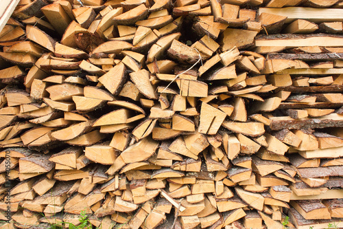 Wood for the village stove or fireplace stacked in a stack. Dry wood texture. Ecologically clean fuel. Selective focus. © Isolda