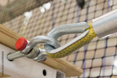 fastening a yellow nylon rope to a metal structure close-up. equipment in the obstacle course photo