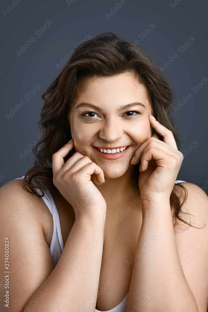 Beautiful plus size woman on grey background. Concept of body positive Beautiful plus size woman on grey background. Concept of body positive