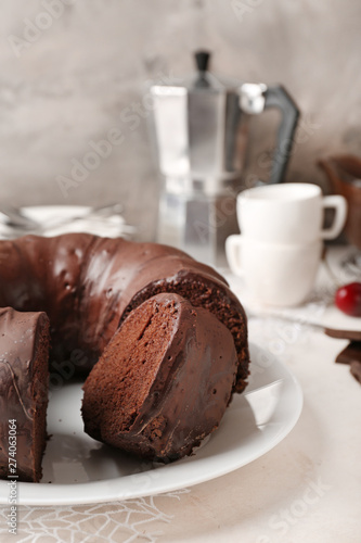 Plate with tasty chocolate cake on table