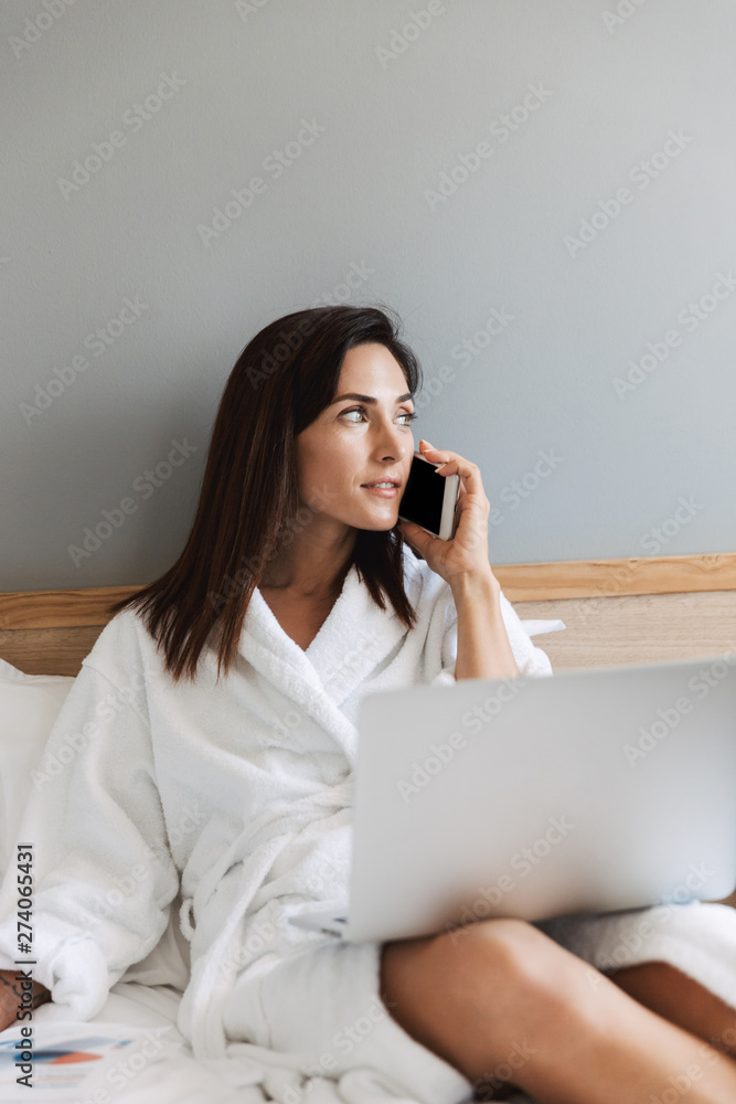 Beautiful young business woman indoors at home using laptop computer. Beautiful young business woman indoors at home using laptop computer.
