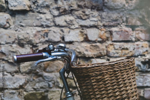 Vintage bike with basket on the wall background
