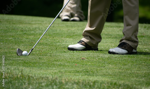 golfer putting on green