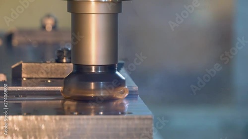 CNC milling machine in operation cutting metal in a manufacturing machine shop
