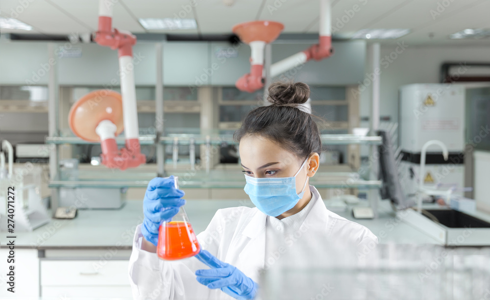 Female scientist looking at the sample in the laboratory Female scientist looking at the sample in the laboratory