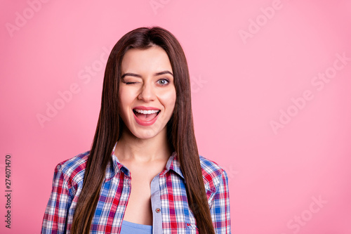 Close-up portrait of her she nice-looking attractive pretty feminine well-groomed cheerful cheery straight-haired girl wearing checked shirt winking holiday isolated over pink background © deagreez