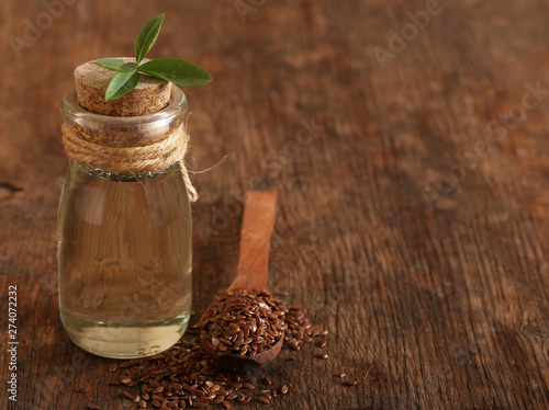 natural organic flaxseed oil on a wooden table