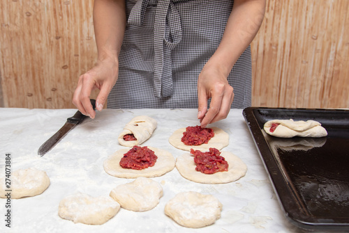 The hostess prepares the pies in the kitchen