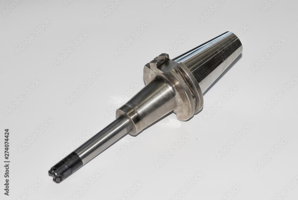 A collet chuck for the end mill with selective focus isolated on white A collet chuck for the end mill with selective focus isolated on white