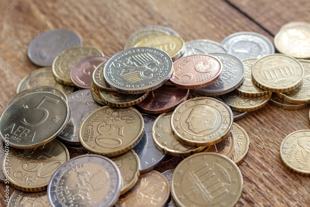 coins old and new Europe euro pile pack heap on a wooden background mock up selective focus close up coins old and new Europe euro pile pack heap on a wooden background mock up selective focus close up