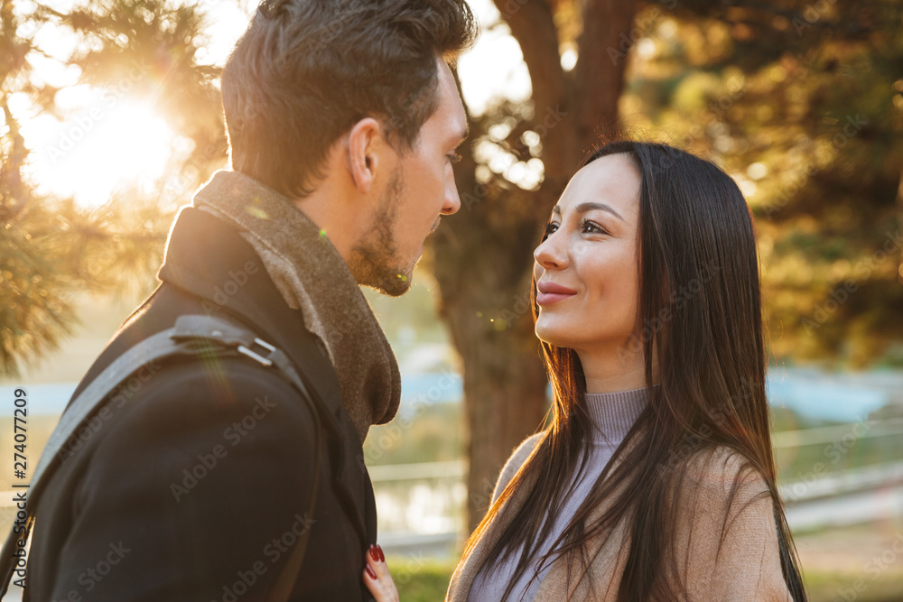 Fototapeta premium Beautiful loving couple posing walking outdoors in park nature.