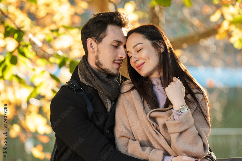Young beautiful loving couple posing walking outdoors in park nature. Young beautiful loving couple posing walking outdoors in park nature.