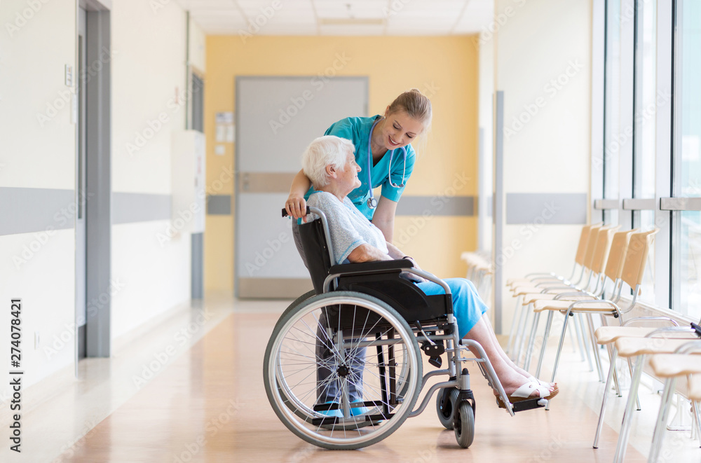 Senior woman in wheelchair with nurse in hospital Senior woman in wheelchair with nurse in hospital