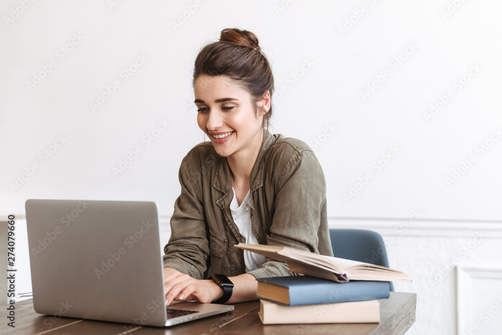 Young happy woman using laptop computer indoors, Young happy woman using laptop computer indoors,