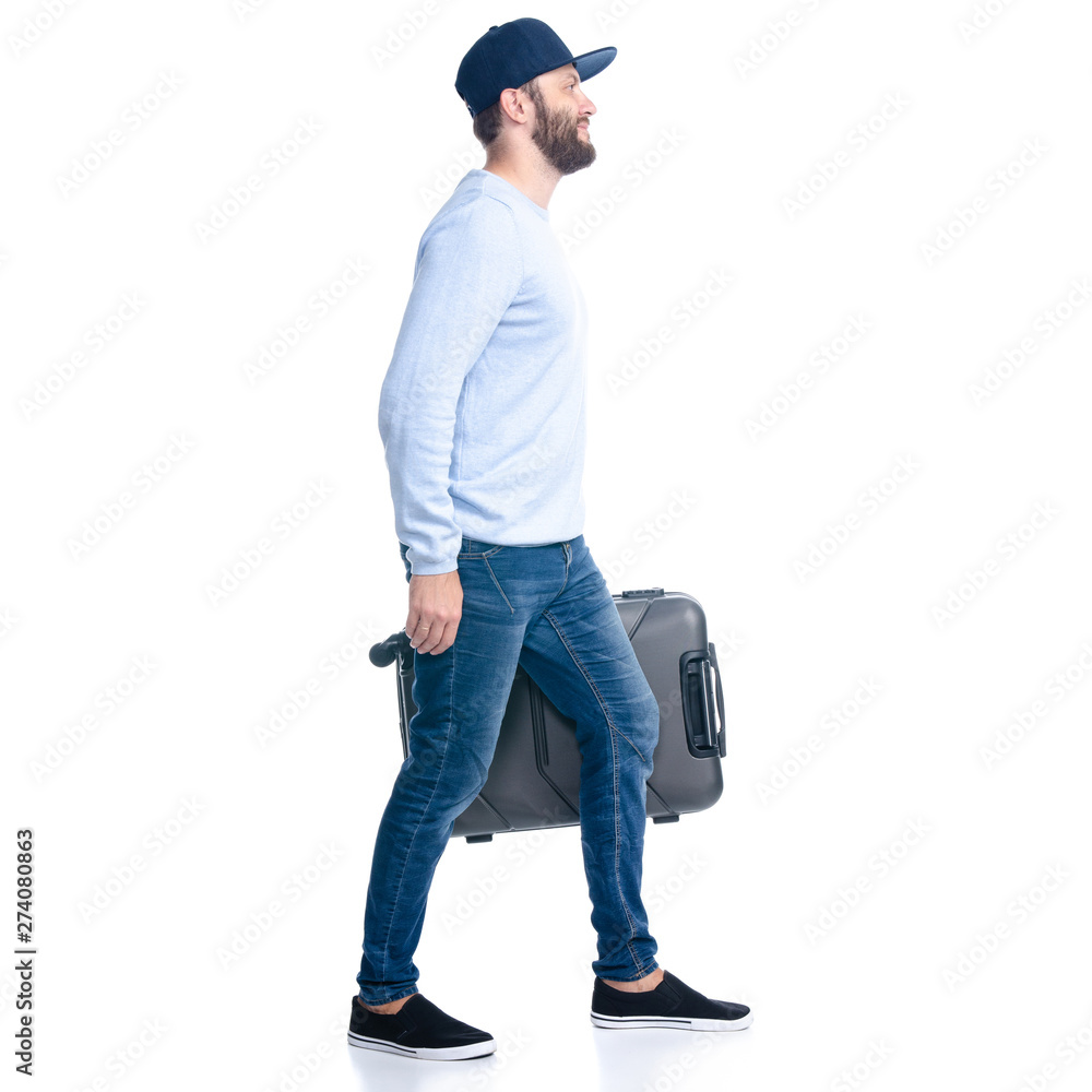 Man in jeans holding travel suitcase goes walking on white background isolation Man in jeans holding travel suitcase goes walking on white background isolation