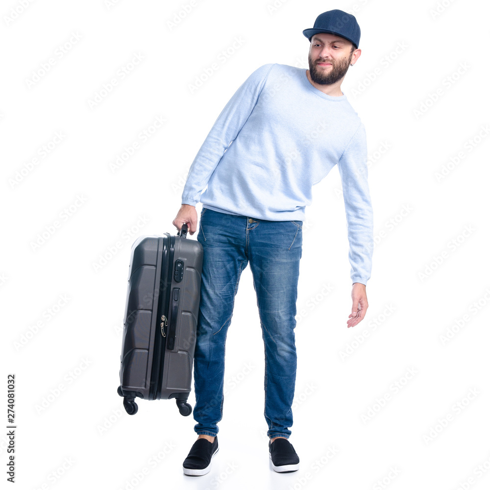Man in jeans holding travel suitcase standing on white background isolation Man in jeans holding travel suitcase standing on white background isolation