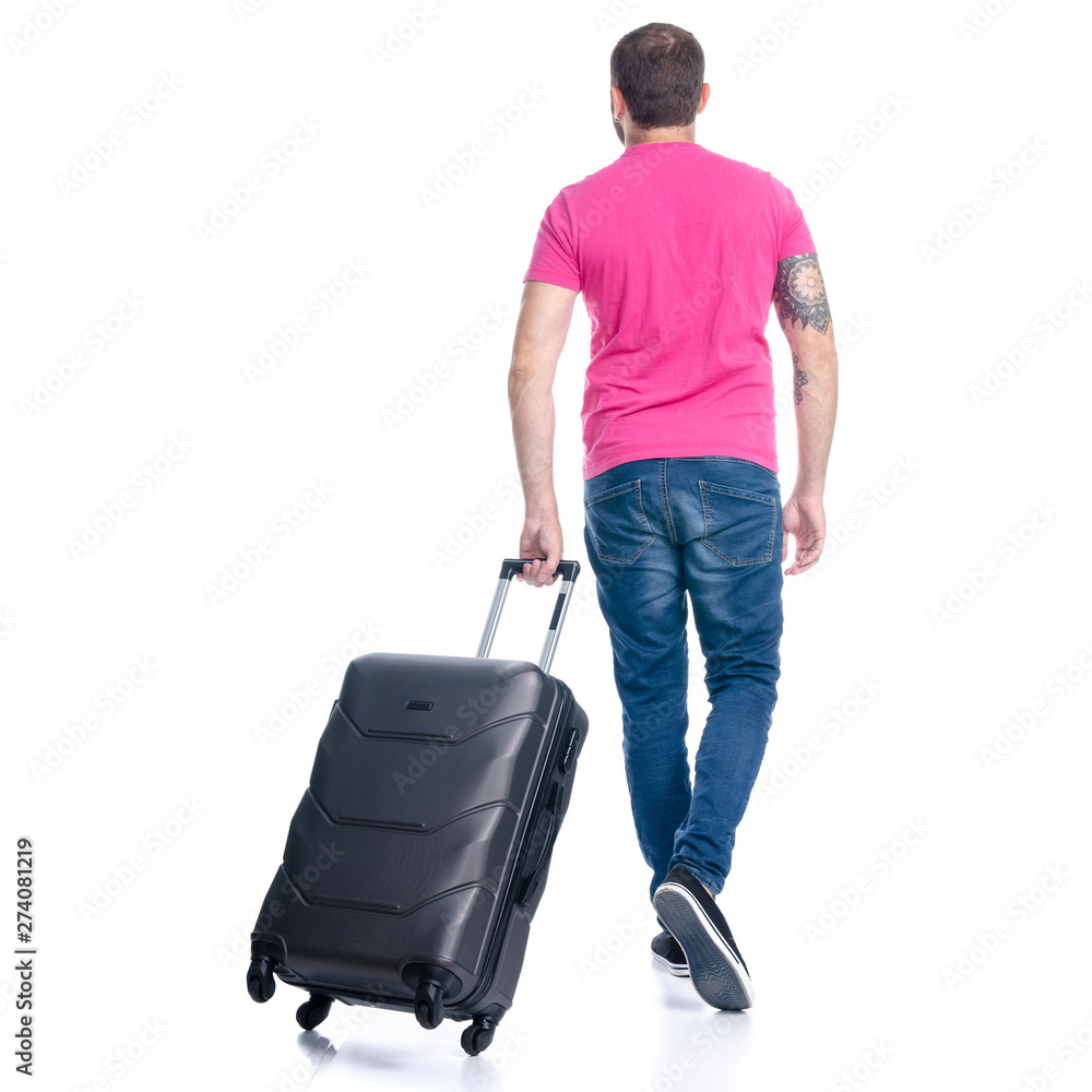 Man in jeans with travel suitcase goes walking on white background isolation, back view Man in jeans with travel suitcase goes walking on white background isolation, back view