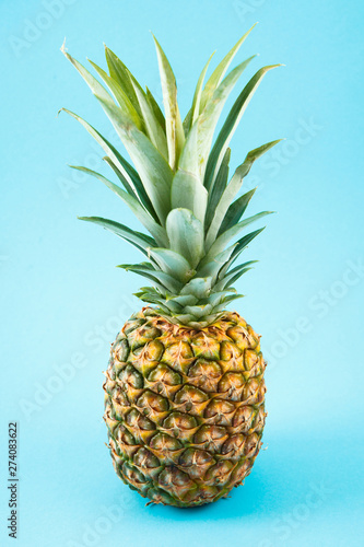 Fresh ripe pineapple on blue background