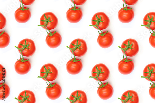 Pattern red tomatoes on a green branch on a white background