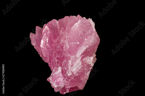 Macro pink quartz mineral stone on black background