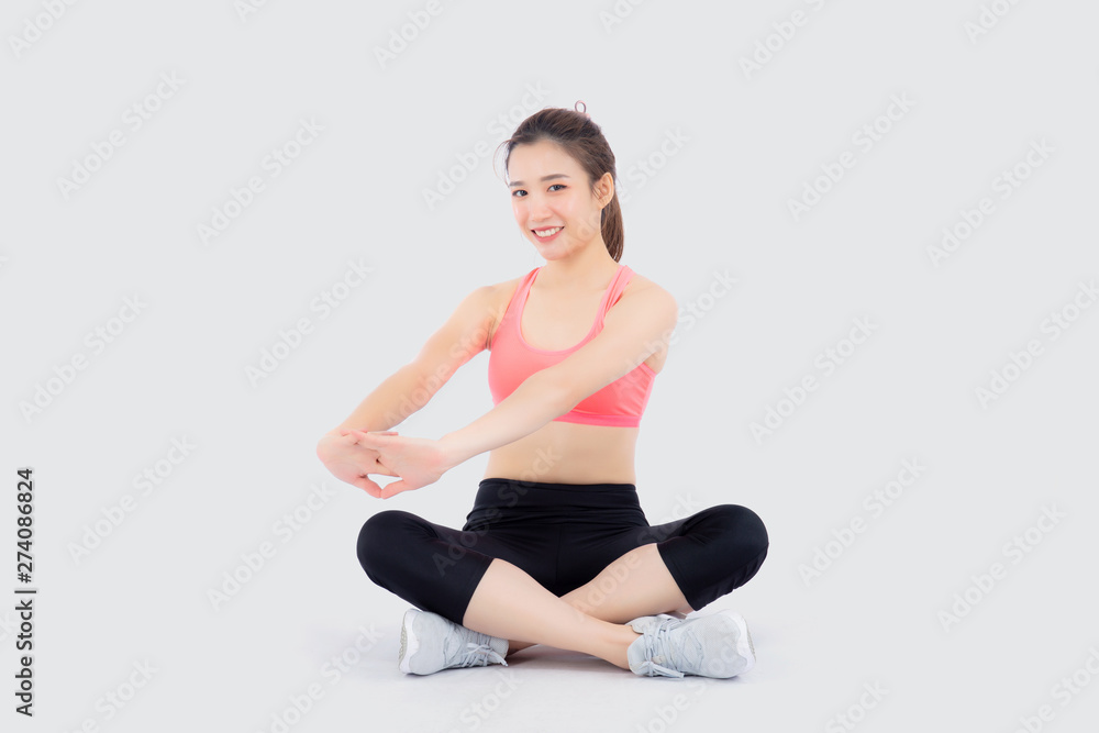 Beautiful portrait young asian woman sitting stretch muscle arm isolated on white background, girl wear sport clothes exercise and yoga for health, wellness concept.