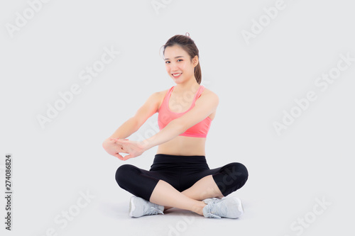 Beautiful portrait young asian woman sitting stretch muscle arm isolated on white background, girl wear sport clothes exercise and yoga for health, wellness concept.