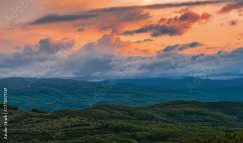 Colorful Spring Sunset over mountains and dramatic sky