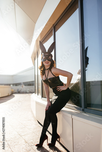 Photography Beautiful, sexy blonde woman in elegant lingerie and black lace Easter bunny mas