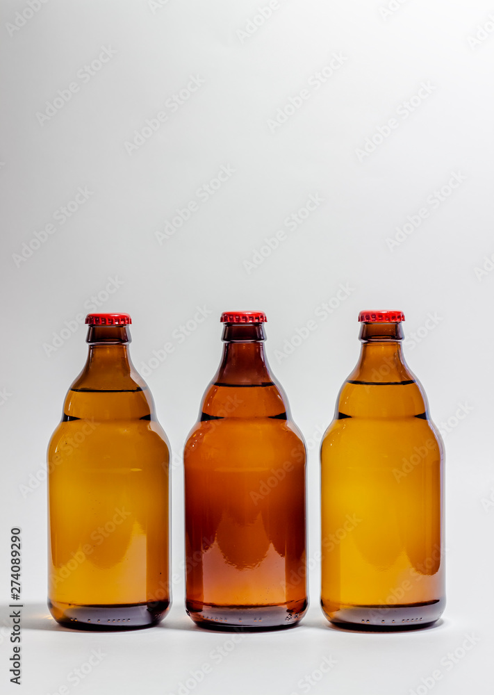 Beer bottles with a red cork on a gray background. Design. Minimalism. Creative idea. Mock-up. Beer bottles with a red cork on a gray background. Design. Minimalism. Creative idea. Mock-up.