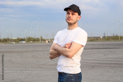 Charismatic man in a white T-shirt. Advertising Banner Fashion and Style. Mockup.Copyspace