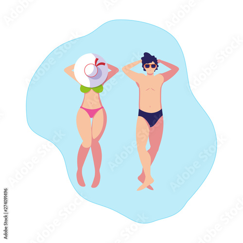 young couple with swimsuit floating in water © djvstock