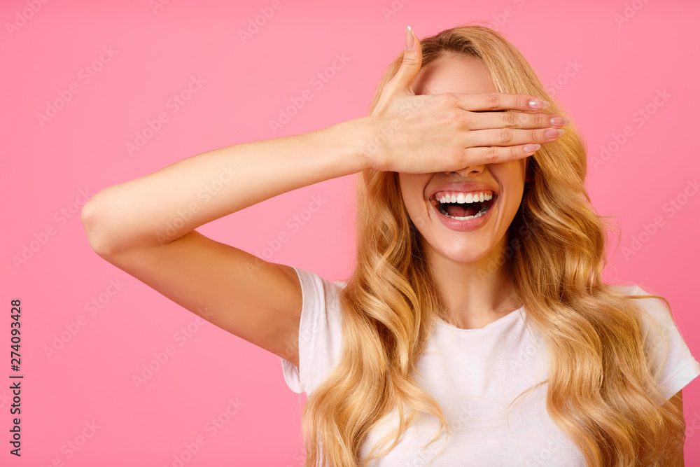 Happy Woman Covering Eyes With Hand, Pink Background Happy Woman Covering Eyes With Hand, Pink Background