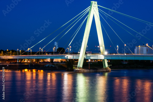 Illuminated bridge accross the river Rhein in Cologne
