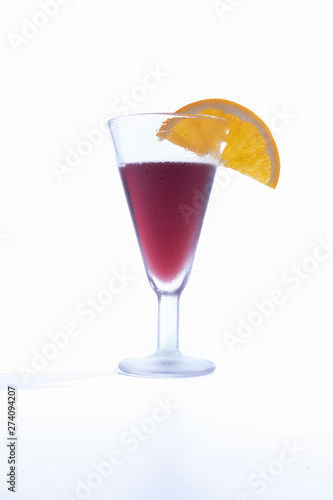 Isolated cup of homemade vermouth decorated with an orange slice