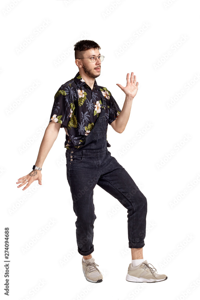 Full-length portrait of a funny guy dancing in studio isolated on white background. Full-length portrait of a funny guy dancing in studio isolated on white background.
