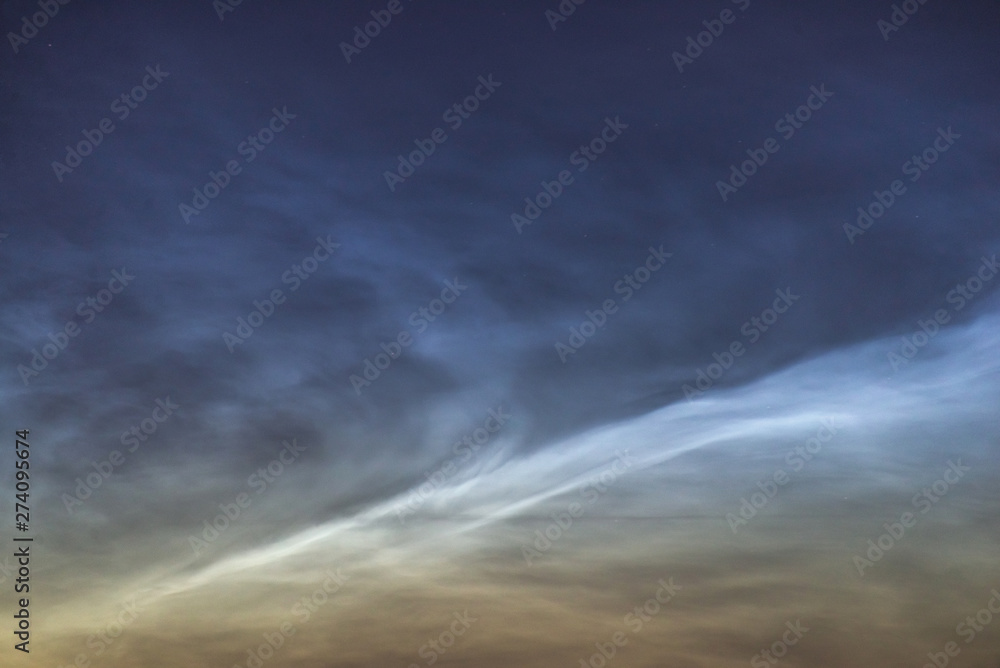 Noctilucent clouds closeup summer night. Noctilucent clouds closeup summer night.