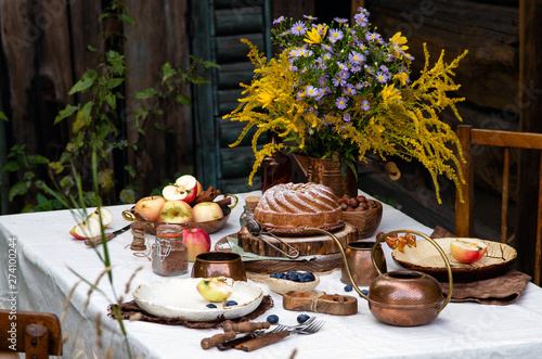 beautiful outdoor still life in country garden with bundt cake on wooden stand on rustic table