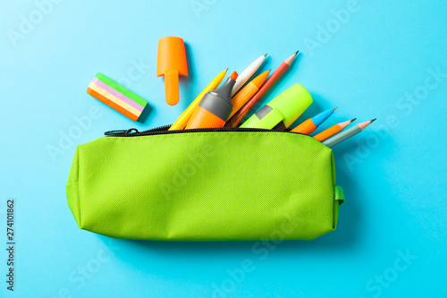 Fotografiet Pencil case with school supplies on blue background, space for text