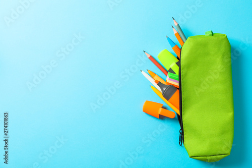 Fotografía Pencil case with school supplies on blue background, space for text