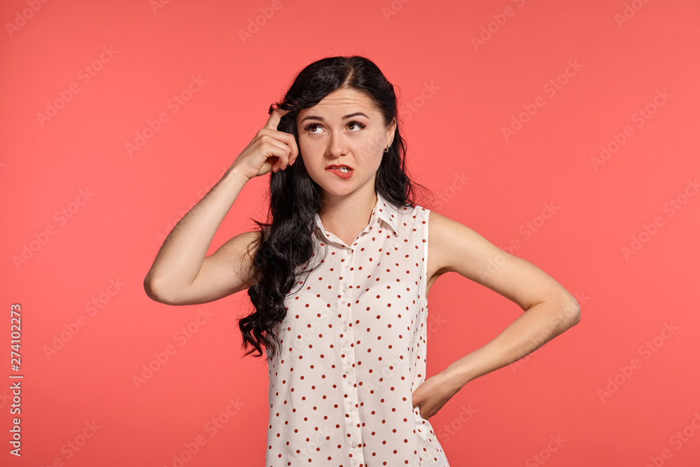 Fototapeta premium Studio shot of a beautiful girl teenager posing over a pink background.